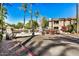 Gated community entrance with palm trees and landscaping at 15050 N Thompson Peak Pkwy # 2006, Scottsdale, AZ 85260