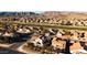 Aerial view of a residential neighborhood near a golf course and mountains at 1705 E Windsong Dr, Phoenix, AZ 85048
