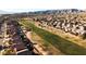 Aerial view of houses and a golf course with mountains in the background at 1705 E Windsong Dr, Phoenix, AZ 85048