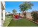 Backyard with firepit and artificial turf at 1705 E Windsong Dr, Phoenix, AZ 85048