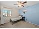 Bright bedroom with a twin bed, nightstand, and ceiling fan at 1705 E Windsong Dr, Phoenix, AZ 85048