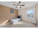 Small bedroom with twin bed and ceiling fan at 1705 E Windsong Dr, Phoenix, AZ 85048