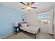 Cozy bedroom with light blue walls and a full-size bed at 1705 E Windsong Dr, Phoenix, AZ 85048