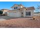 Two-story house with a two-car garage and desert landscaping at 1705 E Windsong Dr, Phoenix, AZ 85048