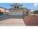 Two-story house with a two-car garage and landscaped front yard at 1705 E Windsong Dr, Phoenix, AZ 85048