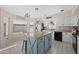 Kitchen boasts an island, stainless steel appliances, and granite countertops at 1705 E Windsong Dr, Phoenix, AZ 85048