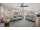 Spacious living room featuring a comfy sofa and access to the kitchen at 1705 E Windsong Dr, Phoenix, AZ 85048