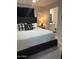 Main bedroom with plush bed, en-suite bathroom access, and calming decor at 2600 E Allred Ave # R87, Mesa, AZ 85204