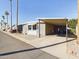 Mobile home with carport and mature landscaping at 2600 E Allred Ave # R87, Mesa, AZ 85204