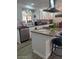 Spacious kitchen boasts granite island, updated appliances, and stylish backsplash at 2600 E Allred Ave # R87, Mesa, AZ 85204