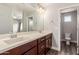 Double vanity bathroom with dark brown cabinets and a large mirror at 2821 S Skyline Dr # 123, Mesa, AZ 85212