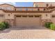 Two-car garage with paver driveway and landscaped surroundings at 2821 S Skyline Dr # 123, Mesa, AZ 85212