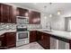Modern kitchen features dark wood cabinets, stainless steel appliances, and mosaic backsplash at 2821 S Skyline Dr # 123, Mesa, AZ 85212