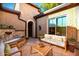 Inviting courtyard featuring a charming fountain, ample seating, and beautiful landscaping for relaxing and entertaining at 28831 N 128Th Dr, Peoria, AZ 85383