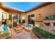 Charming outdoor courtyard with comfortable seating, stylish decor, and a tranquil fountain, ideal for relaxation at 28831 N 128Th Dr, Peoria, AZ 85383