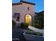 Charming home entrance with arched doorway, lush landscaping, and stone accents at 28831 N 128Th Dr, Peoria, AZ 85383