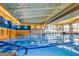 Bright indoor swimming pool with large windows and blue and white lanes at 28831 N 128Th Dr, Peoria, AZ 85383