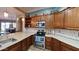 Bright kitchen with stainless steel appliances, granite counters and wooden cabinets at 28831 N 128Th Dr, Peoria, AZ 85383
