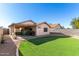 Landscaped backyard with grassy area and patio at 3150 W Foothill Dr, Phoenix, AZ 85027