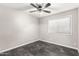 Well-lit bedroom featuring a ceiling fan and dark flooring at 3150 W Foothill Dr, Phoenix, AZ 85027