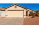 Tan house with a beige garage door and small front yard at 3150 W Foothill Dr, Phoenix, AZ 85027
