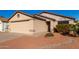 Tan house with a beige garage door and small front yard at 3150 W Foothill Dr, Phoenix, AZ 85027