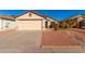 Tan house with a beige garage door and small front yard at 3150 W Foothill Dr, Phoenix, AZ 85027