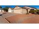 Tan house with a beige garage door and small front yard at 3150 W Foothill Dr, Phoenix, AZ 85027