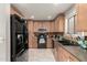 Well-equipped kitchen featuring light wood cabinets and black appliances at 3150 W Foothill Dr, Phoenix, AZ 85027