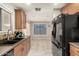 Open kitchen with dark countertops and wood cabinets at 3150 W Foothill Dr, Phoenix, AZ 85027