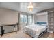 Cozy bedroom featuring a murphy bed, a chandelier, and a desk by the window at 4600 N 68Th St # 313, Scottsdale, AZ 85251