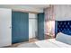 This bedroom showcases a closet with open doors and a view of the wallpapered bedroom at 4600 N 68Th St # 313, Scottsdale, AZ 85251