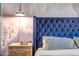 The bedroom's plush blue headboard and stylish lighting create an inviting atmosphere at 4600 N 68Th St # 313, Scottsdale, AZ 85251