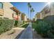 Inviting condo exterior featuring lush landscaping, manicured hedges, and a walkway to the parking at 4600 N 68Th St # 313, Scottsdale, AZ 85251