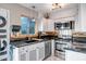 Bright kitchen featuring white cabinetry, granite countertops, and stainless steel appliances at 4600 N 68Th St # 313, Scottsdale, AZ 85251