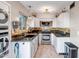Bright kitchen featuring white cabinetry, granite countertops, and stainless steel appliances at 4600 N 68Th St # 313, Scottsdale, AZ 85251