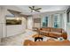 Spacious living room boasts neutral paint, tile floors, large windows, and leather furnishings at 4600 N 68Th St # 313, Scottsdale, AZ 85251