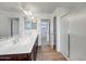 Bathroom with double sinks, modern vanity and glass enclosed shower at 5534 W Banff Ln, Glendale, AZ 85306