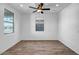 Clean bedroom design with tiled floors, a ceiling fan, and ample natural light from two windows at 5534 W Banff Ln, Glendale, AZ 85306