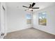Bedroom with carpeted floor, ceiling fan and two windows at 5534 W Banff Ln, Glendale, AZ 85306