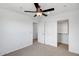 Bedroom featuring carpeted floor, ceiling fan and closet at 5534 W Banff Ln, Glendale, AZ 85306