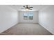 Spacious bedroom with neutral carpet, white walls, and large windows at 5534 W Banff Ln, Glendale, AZ 85306