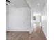 Hallway with wood-look flooring, neutral walls, and natural light streaming through the windows at 5534 W Banff Ln, Glendale, AZ 85306