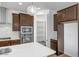A gourmet kitchen featuring a pantry, stainless steel appliances and an island with a white countertop at 5534 W Banff Ln, Glendale, AZ 85306