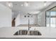 Open-concept floor plan featuring a modern kitchen island and access to a spacious living room at 5534 W Banff Ln, Glendale, AZ 85306