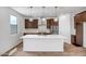Open-concept kitchen with a large island, stainless steel appliances, and modern pendant lighting at 5534 W Banff Ln, Glendale, AZ 85306