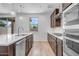 Modern kitchen featuring an island, tile backsplash, stainless steel appliances, and a view from the window at 5534 W Banff Ln, Glendale, AZ 85306