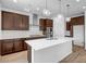 Bright kitchen with a large island, stainless steel appliances, and stylish wood floors at 5534 W Banff Ln, Glendale, AZ 85306