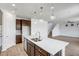 Spacious kitchen with an island, stainless steel appliances, and view of the open-concept living space at 5534 W Banff Ln, Glendale, AZ 85306