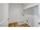 A well-lit laundry room with wood-look tile flooring and a shelf at 5534 W Banff Ln, Glendale, AZ 85306